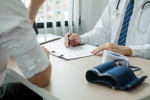 Doctor reviewing medical records with a patient, illustrating the process of evaluating clinical evidence for legal or expert witness purposes.