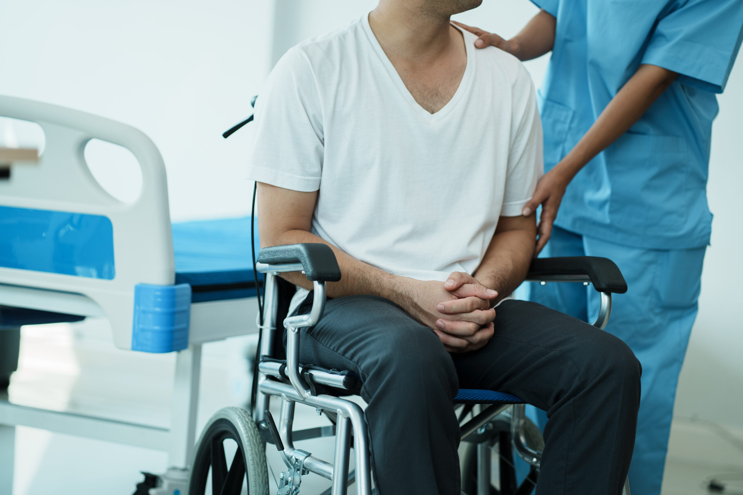 Caring female doctor in medical touch and support male patient in hospital.